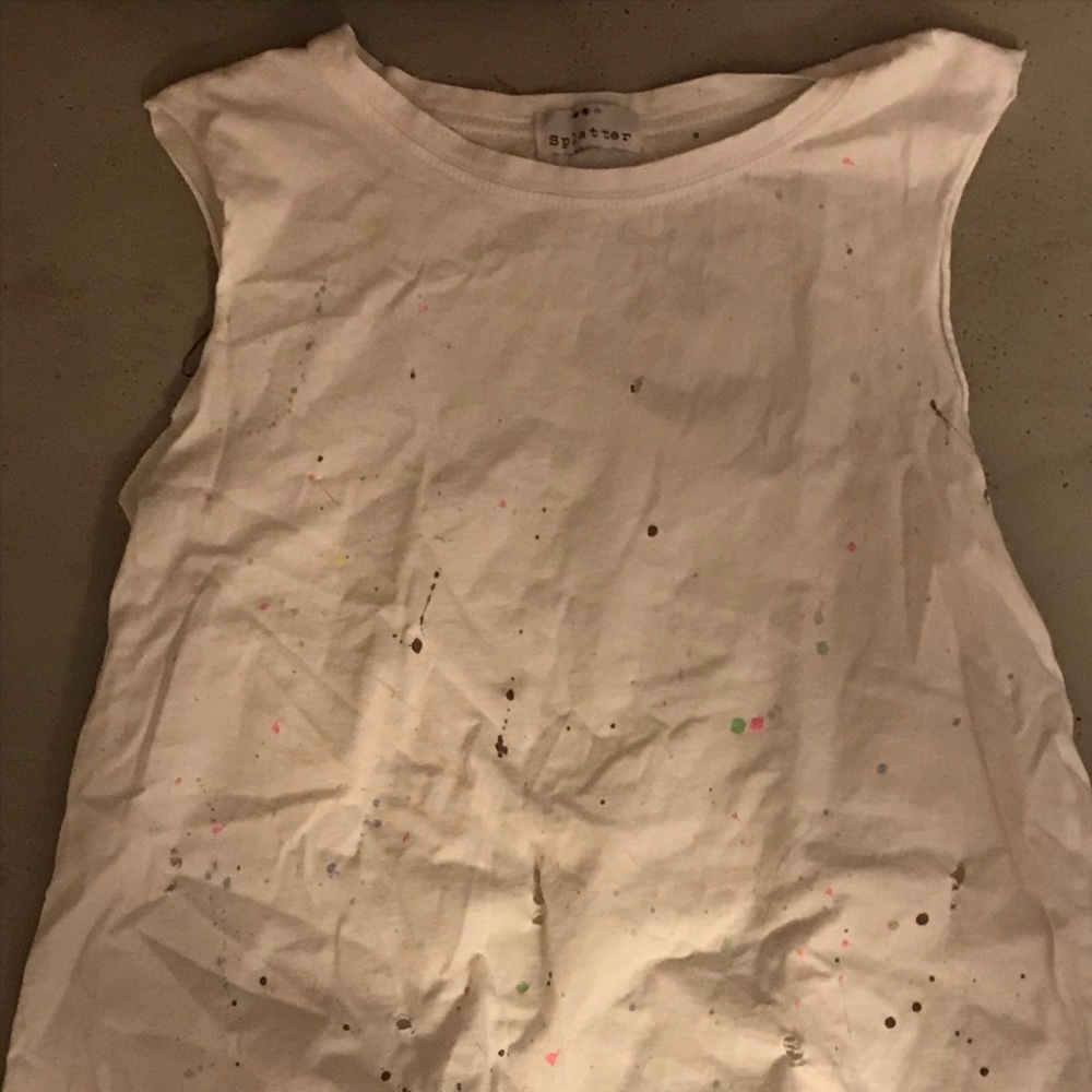 This is a tank top with paint splatters and rips.